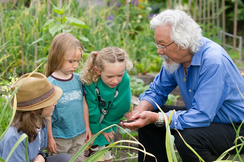 Des enfants et David Suzuki se rassemblent dans un jardin